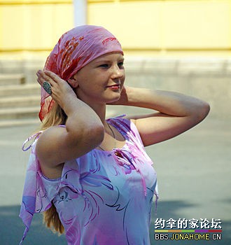 Russian_woman_putting_headscarf.jpg